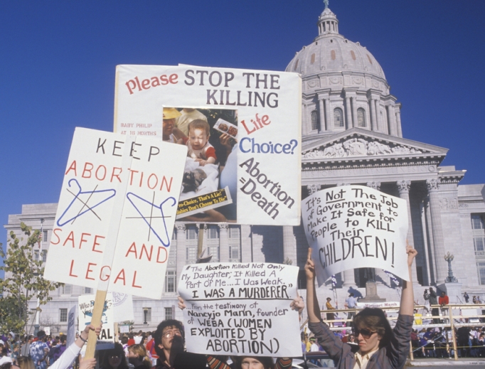Women's rights marchers holding signs at State Capitol Building, Missouri, May 21, 2019. 