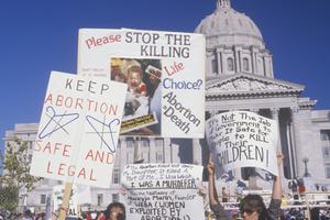 Women's rights marchers holding signs at State Capitol Building, Missouri, May 21, 2019. 