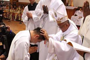 Above, Bishop Wenceslao Selga Padilla ordains Father Joseph Enkh-Baatar; below, Father Enkh-Baatar offers blessings.
