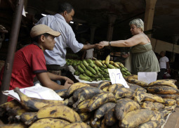 A woman buys food at a market in Havana, Cuba, Aug. 3.