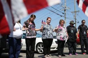 College students and others gather in prayer across the street where a gunman attacked a recruiting office in Chattanooga, Tenn. on July 17, 2015.