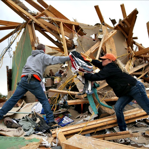 Volunteers help clean debris at the site of a home that was destroyed after a tornado April 29 in Vilonia, Ark. Deadly tornadoes ripped through the region April 27, leaving more than a dozen dead.
