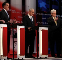 Mitt Romney (l) and Ron Paul (c) listen while Newt Gingrich makes a point during the debate at St. Anselm College prior to the New Hampshire primary.