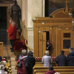 Parishioners wait in line for confession at St. Hyacinth Basilica in Chicago. 
