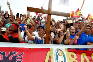 World Youth Day pilgrims await the arrival of Pope Francis at the Jasna Gora Monastery in Czestochowa, Poland, on July 28. Below, pilgrims wave Panama flags as the Pope celebrates Mass in Brzegi, near Krakow, Poland, on July 31. During the closing Mass for World Youth Day, the Holy Father announced that Panama will be the host city of the next festival.