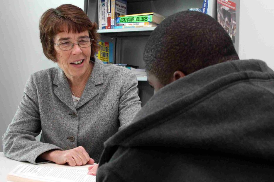 Mercy Sister Mary Scullion reads with a young man at the Project H.O.M.E center in Philadelphia April 3.