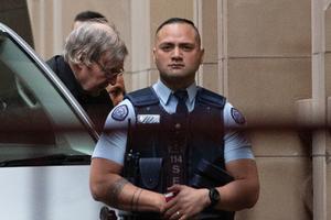 Australian Cardinal George Pell (c) is escorted into the Supreme Court of Victoria in Melbourne on Aug. 21, the day his appeal against sex-abuse charges was rejected. 