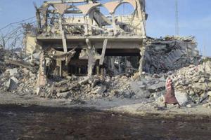 A man walks past the wreckage of a building at the site of an attack in the Somali capital of Mogadishu Oct. 15.