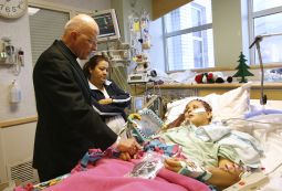 Chicago Cardinal Francis George visits a patient at Children's Memorial Hospital in Chicago in this December 2008 file photo. 