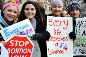 Young people hold pro-life signs during the 2015 March for Life in Washington on Jan. 22.