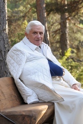 Pope Benedict sits on a bench during vacation in the Italian Alps. (CNS photo)
