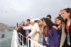 Pope Benedict XVI waves from the deck of a catamaran as he arrives to the Valletta waterfront to attend a meeting with youths in Floriana April 18 during his trip to Malta. 
