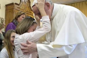 Holy Father shares a blessed moment with a young resident of St. Alessio-Margherita di Savoia Regional Center.