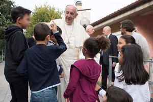 Pope Francis visits children at the SOS Village in Rome Oct. 14.