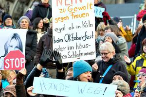 Women protest against the New Year's Eve attacks on women by Muslim refugees near the cathedral in Cologne, Germany. The sign says, "No to violence against women, whether in Cologne, at Oktoberfest, or in the house or bedroom."