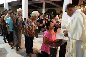 Survivors of Super Typhoon Haiyan receive Holy Communion in the Philippine village of San Joaquin in Palo on Dec. 24, 2013.
