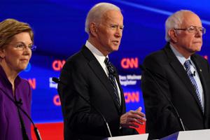 Democratic presidential hopefuls Massachusetts Sen. Elizabeth Warren, l, former Vice President Joe Biden, c, and Vermont Sen. Bernie Sanders participate in the seventh Democratic primary debate of the 2020 presidential campaign season co-hosted by CNN and the Des Moines Register at Drake University in Des Moines, Iowa, on Jan. 14.