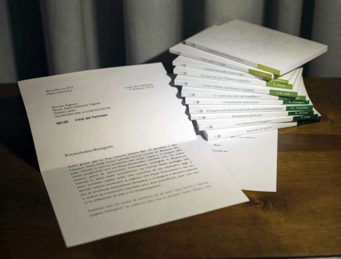 A letter by retired Pope Benedict is seen in this photo, released March 13, that the Vatican admitted
was doctored, by blurring its final two lines, where retired Pope Benedict begins to acknowledge that he
didn’t read an 11-volume set of books about Pope Francis’ theology, seen at right, and doesn’t have time to comment
on them. The Vatican announced March 21 that the head of the Vatican’s communications department,
Msgr. Dario Viganò, had resigned over a scandal about the letter, indicating that he mischaracterized it in public
and then digitally manipulated it in the photograph sent to the media.