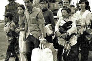 South Vietnamese refugees walk across a U.S. Navy vessel. Operation Frequent Wind, the final operation in Saigon, began April 29, 1975. During a nearly constant barrage of explosions, the Marines loaded U.S. and Vietnamese civilians, who feared for their lives, onto helicopters that brought them to waiting aircraft carriers. The Navy vessels brought them to the Philippines and eventually to Camp Pendleton, Calif.