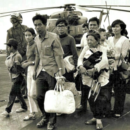 South Vietnamese refugees walk across a U.S. Navy vessel. Operation Frequent Wind, the final operation in Saigon, began April 29, 1975. During a nearly constant barrage of explosions, the Marines loaded U.S. and Vietnamese civilians, who feared for their lives, onto helicopters that brought them to waiting aircraft carriers. The Navy vessels brought them to the Philippines and eventually to Camp Pendleton, Calif.