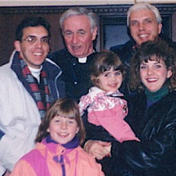 Father Mychal Judge with the Lynch family in the early 1990s. Kelly Ann, at right, holds daughter Shannon.