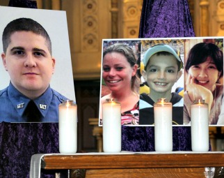 Pictures of the victims of the alleged Boston Marathon bombers, (l to r) Sean Collier, Krystle Campbell, Martin Richard and Lu Lingzi, at Boston's Cathedral of the Holy Cross.