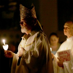 LEADING THE WAY. Cardinal Se&#225;n O'Malley of Boston holds a candle as he leads a procession during an Easter Vigil service at the Cathedral of the Holy Cross in 2006 in Boston.