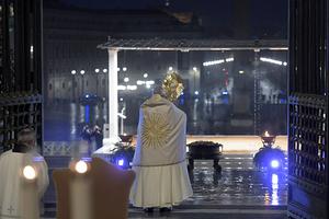 Holding the Blessed Sacrament in a monstrance, Pope Francis stands before an empty St. Peter’s Square — and a large TV, radio and internet audience worldwide — as he blesses “the City (of Rome) and the World” (Urbi et Orbi) Friday.