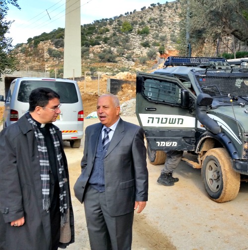 Above, Bishop Oscar Cantu of Las Cruces, N.M., with a landowner; below, olive trees uprooted for the barrier and bishops refused entry.