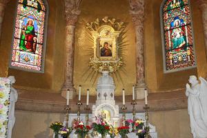 The ‘miraculous’ icon of Our Lady of Perpetual Help (above) is the centerpiece of Boston’s basilica, whose main interior and exterior are also shown.