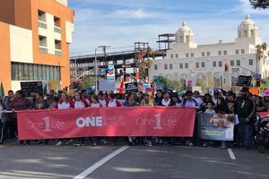Above, OneLife LA steps off Jan. 18 to support the gospel of life. Below, the many faces coming out to support life included Archbishop José Gomez and speaker Daniel Ritchie. Also below, members of St. Linus in Norwalk and St. Rose of Lima parishes and students from Thomas Aquinas College were part of the pro-life throng. 