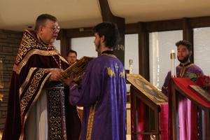 Father David Anderson chants the Gospel for the feast of the Exaltation of the Cross at Wyoming Catholic College. 