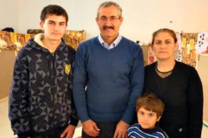 Imad Ibraheem Daood with his wife, Sajida, and two of their four children, in a refugee center in Amman.
