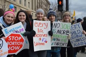 Young people hold signs opposing abortion during a past March for Life in Washington. 