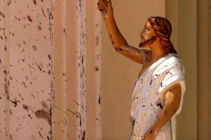 Blood stains are seen on the wall and on a Jesus Christ statue at St. Sebastian's Church April 21 after a blast in Negombo, north of Colombo, Sri Lanka. Sri Lankan authorities blame a militant group for coordinated Easter bombings that ripped through Sri Lankan churches and luxury hotels, killing and injuring hundreds of people. It was Sri Lanka's deadliest violence since a devastating civil war in the South Asian island nation ended a decade ago. 