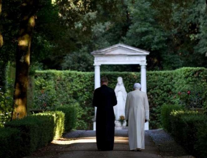 Pope emeritus Benedict XVI walking in the gardens at Castel Gandolfo. 