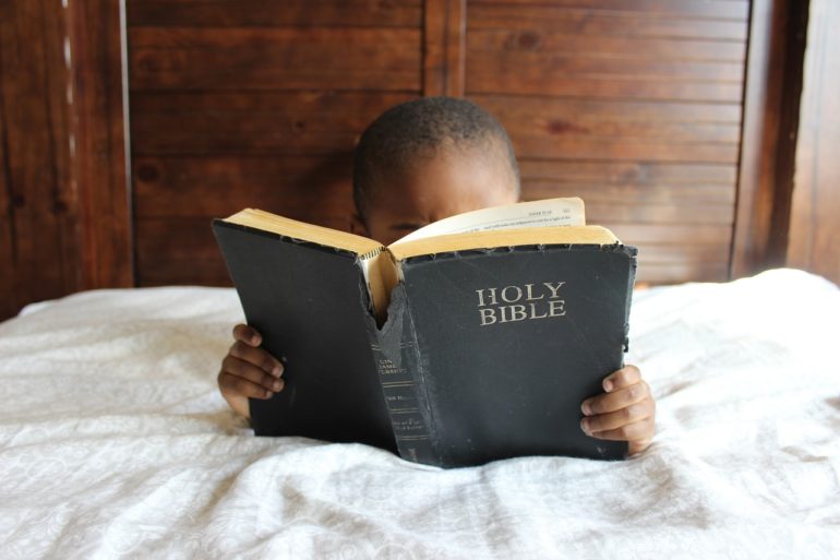 Child reading the Holy Bible