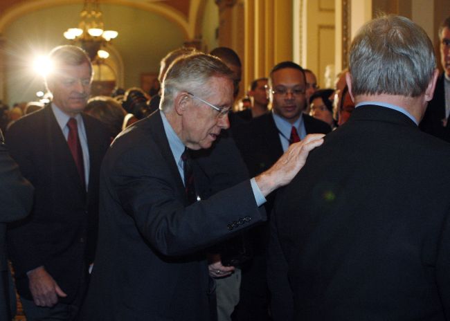 HEALTH VOTE. U.S. Senate Majority Leader Harry Reid, D-Nev., puts his hand on the back of Sen. Richard Durbin, D-Ill., as Sen. Max Baucus, D-Mont., follows behind after the U.S. Senate approved President Obama's health-care overhaul in Washington Dec. 24. By a 60-39 vote, senators backed sweeping changes in the medical-insurance market and new coverage for tens of millions of uninsured Americans.