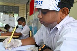 A student wearing a face shield sits in a classroom after their school was reopened in Colombo, Sri Lanka, July 6.