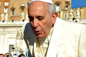 Pope Francis blows out candles on a cake for his 78th birthday in St. Peter’s Square during his Wednesday general audience on Dec. 17.