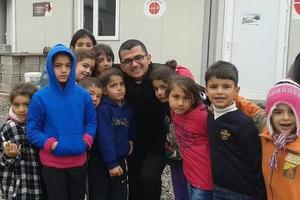 Seminarian Remi Marzina Momica with a group of children outside an Aid to the Church in Need office.