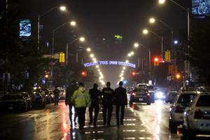 Toronto police officers work at the scene of a shooting in Toronto July 23. A gunman opened fire in central Toronto on Sunday night, injuring 13 people and killing two, including a child, police reported. 