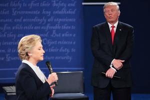 Democratic presidential nominee Hillary Clinton speaks as Republican presidential nominee Donald Trump listens during the town-hall debate at Washington University on Oct. 9 in St. Louis, Missouri. 