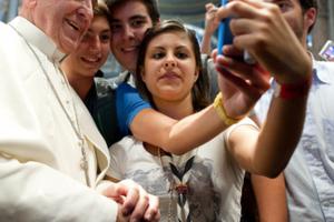 Pope Francis and youth take a selfie.