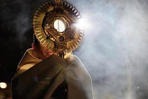 Father Michael Delcambre of Broussard, Louisiana, carries the Blessed Sacrament in procession.