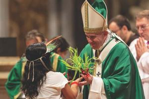 Pope Francis accepts a gift at the Mass for the closing of the Amazon synod Oct. 27.
