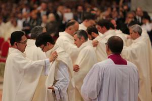 New priests are clothed with chasubles during their ordination Mass in St. Peter’s Basilica April 26, 2015. 