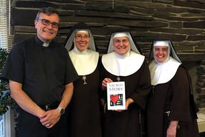 Father Bill Watson, shown with Poor Clares of Perpetual Adoration from the Monastery of St. Michael the Archangel, and his Sacred Story Institute promote Ignatian spirituality. 