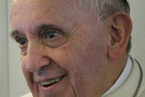 Pope Francis speaks with journalists on the papal plane on the return flight to Rome Aug. 18.
