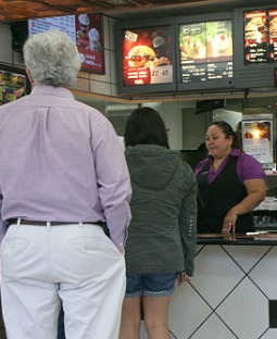 McDonald's employee serves customers in Raleigh, N.C., in October 2011